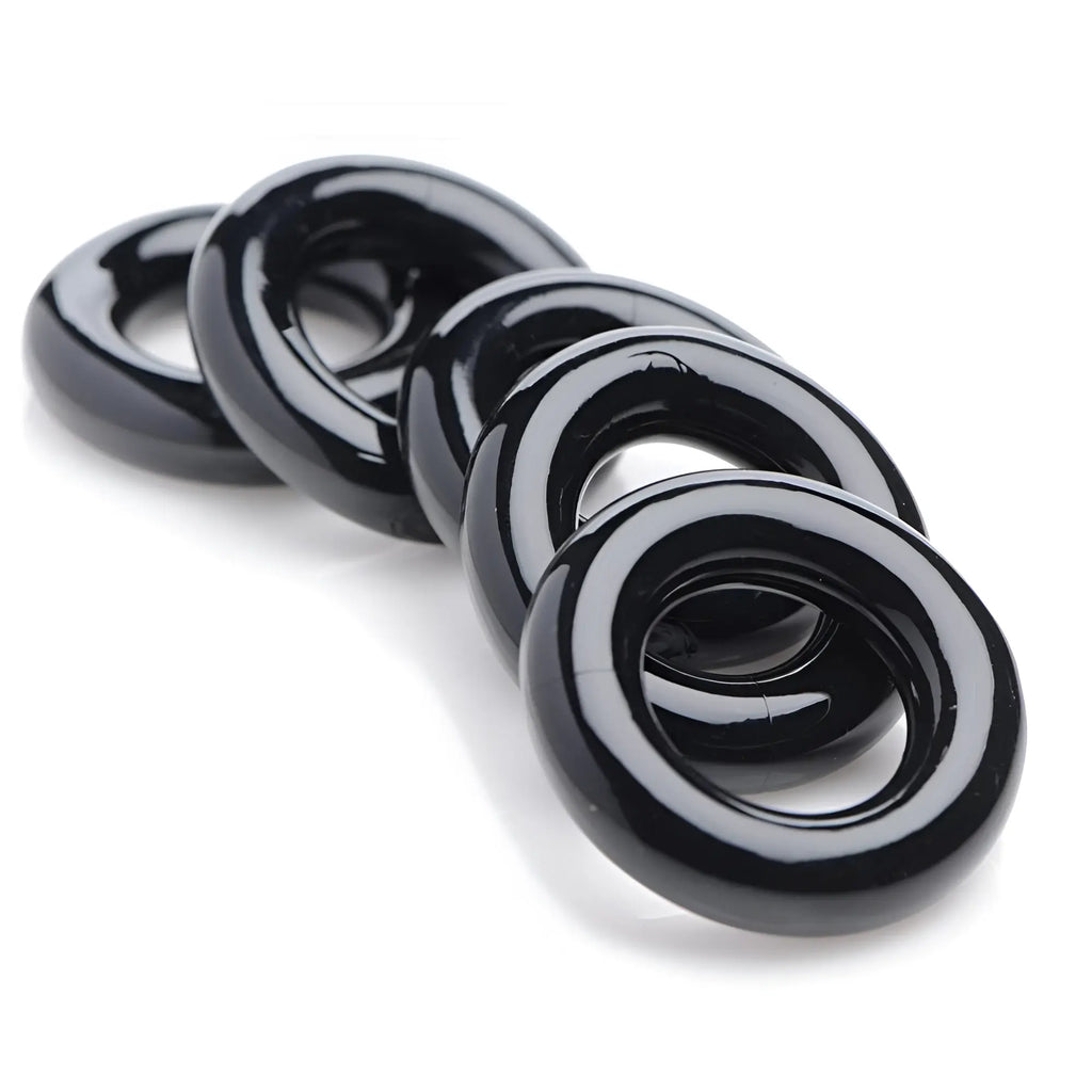 Master Series Ring Master Custom Ball Stretcher Kit: Four smooth, glossy black, circular silicone rings in a row.