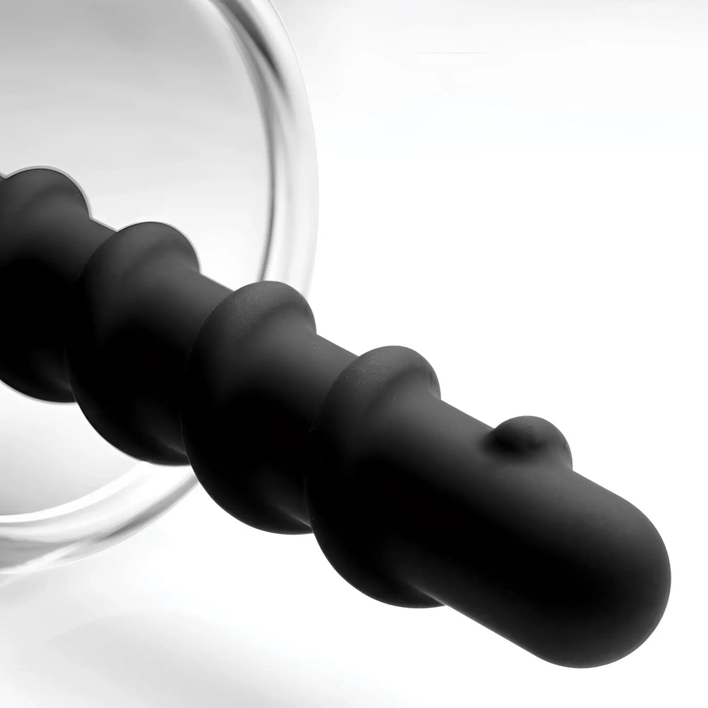 Master Series Rosebud Driller: A matte black, spiraled silicone insert with a rounded tip and a translucent base.