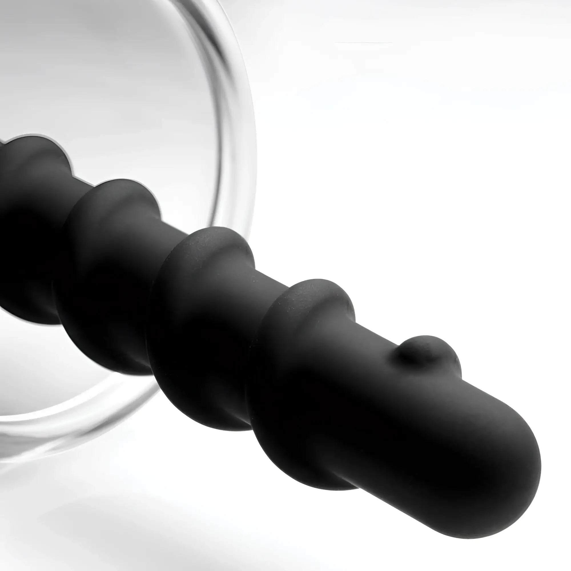 Master Series Rosebud Driller: A matte black, spiraled silicone insert with a rounded tip and a translucent base.