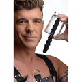 Man holding a clear Master Series Rosebud Driller cylinder with a black spiral silicone insert.