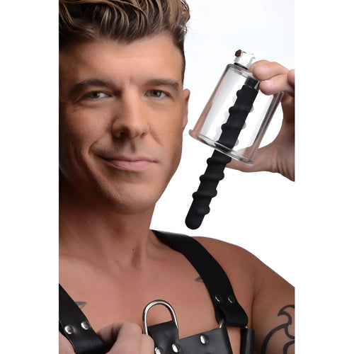 Man holding a clear Master Series Rosebud Driller cylinder with a black spiral silicone insert.