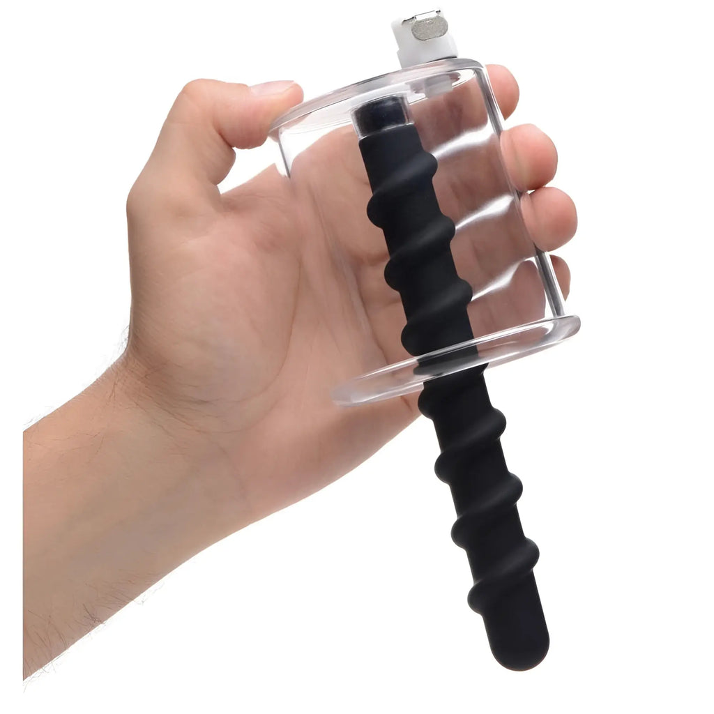 A hand holding the Master Series Rosebud Driller, a clear cylinder with a black, spiraled silicone insert.