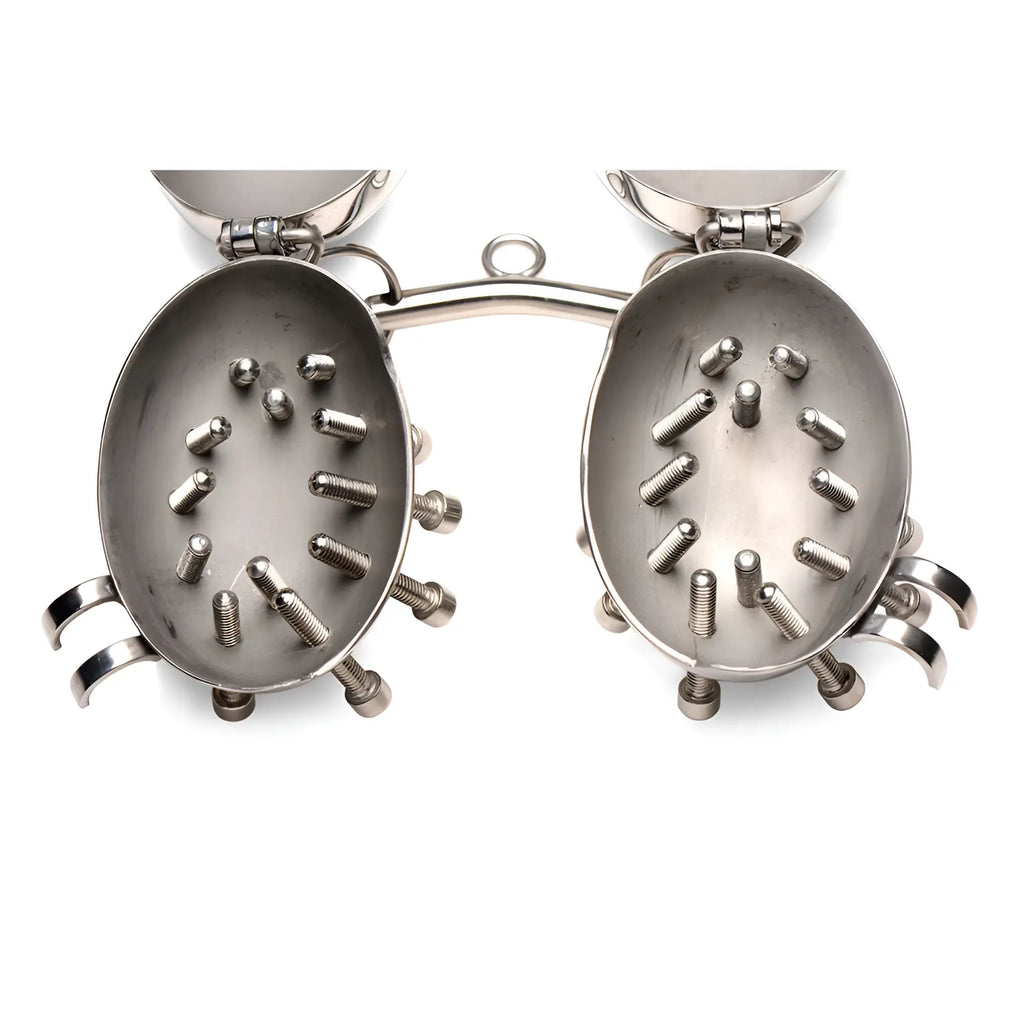 Master Series Scrotum Egg Shells in silver metal, featuring an open-hinged design lined with interior spikes.