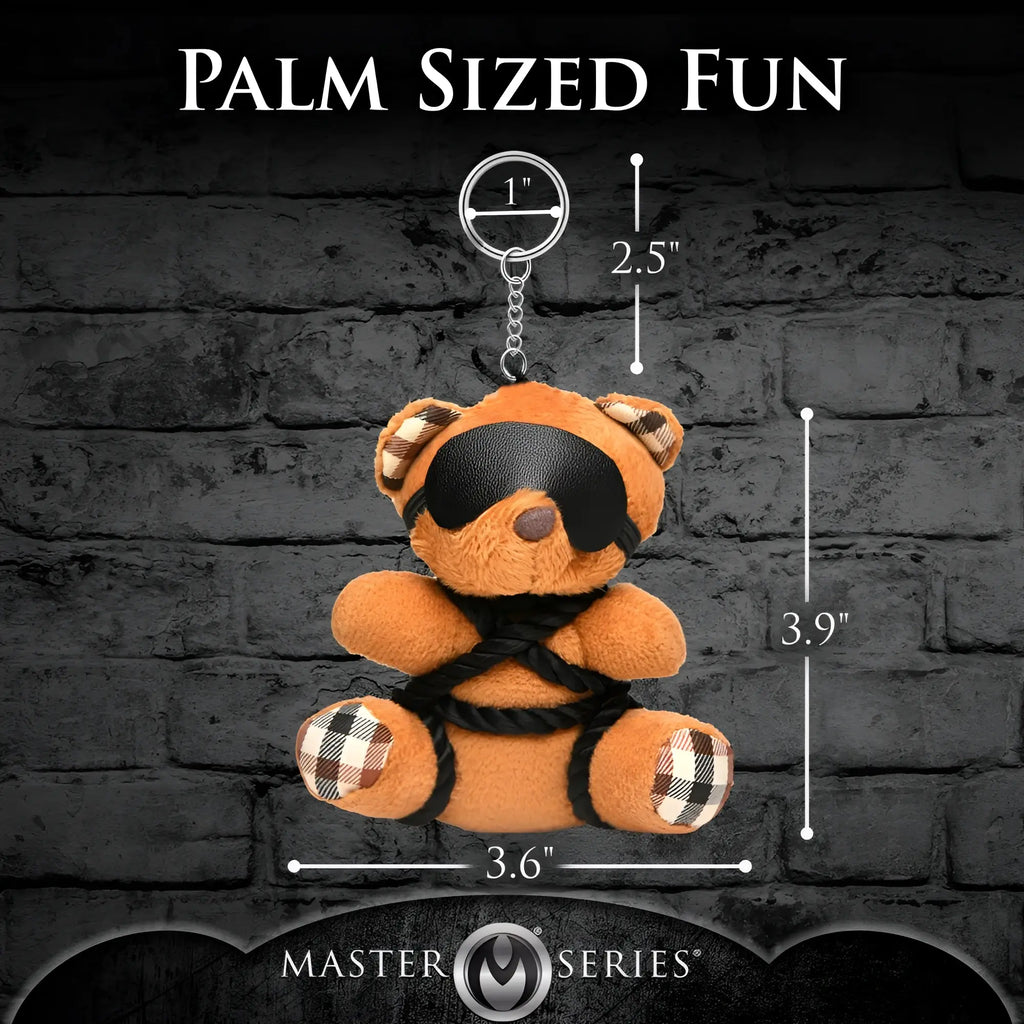 Master Series ShiBeari brown plush teddy bear keychain wearing a black blindfold and black rope, with measurement labels.