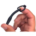 Master Series Silicone Cum-Thru D-Ring Penis Plug: a black, flexible, tapered plug with a D-ring handle held by a hand.
