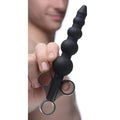 Master Series black silicone graduated beads lubricant launcher held by a hand, featuring a three-ring syringe handle.