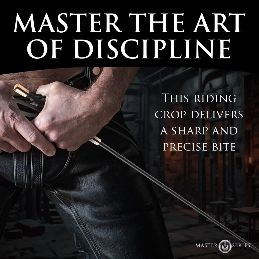 Master Series Sinful Impact Cane: A sleek black riding crop with gold-tone accents held by a person in leather pants.