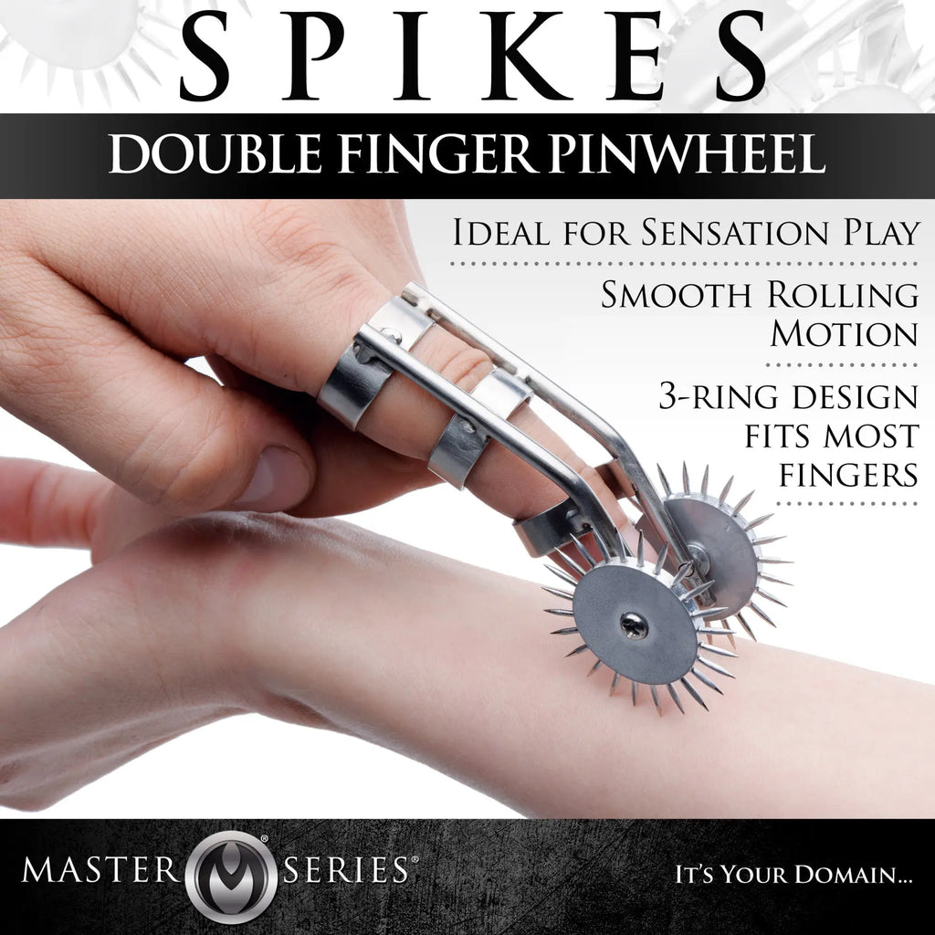 Master Series Spikes Double Finger Pinwheel with silver rings and two sharp rotating wheels worn on a finger.