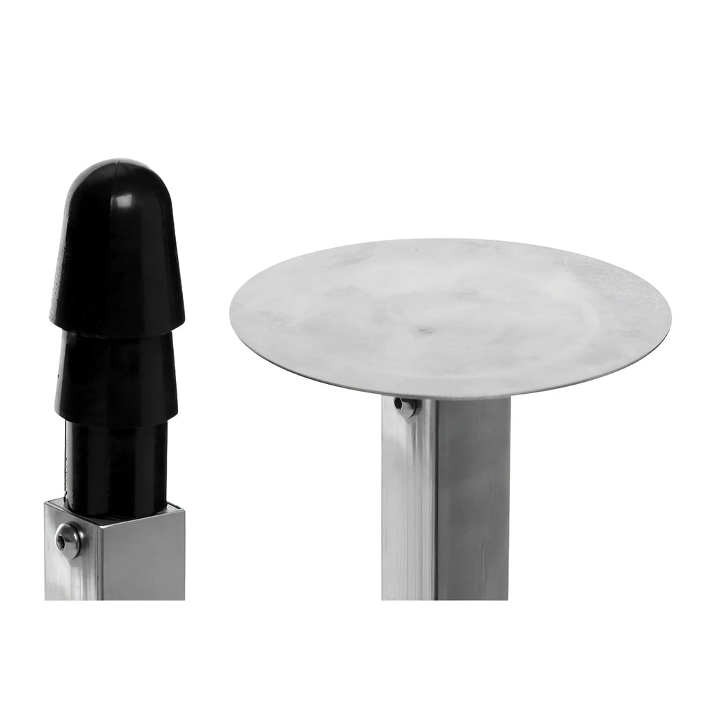Master Series Squat Impaler showing a black, stepped plug next to a flat, circular silver base on metal stands.