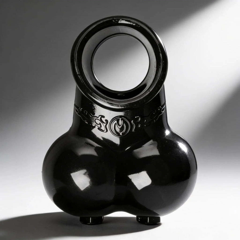 Master Series Squeeze My Sack: A glossy, black, anatomical-style silicone erection enhancer with a scrotal pouch.
