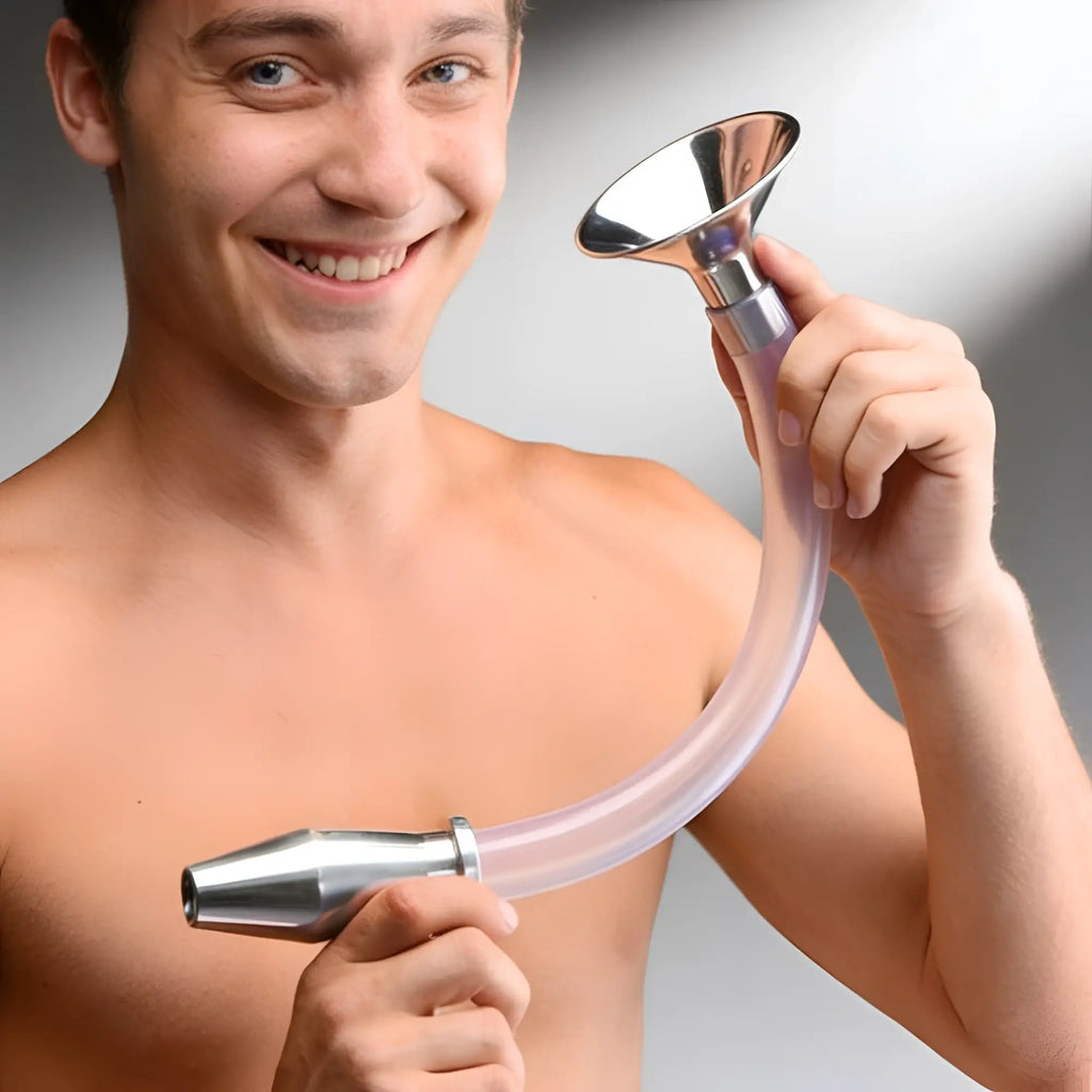 A smiling man holding a Master Series stainless steel funnel attached to a long, curved clear tube and hollow anal plug.