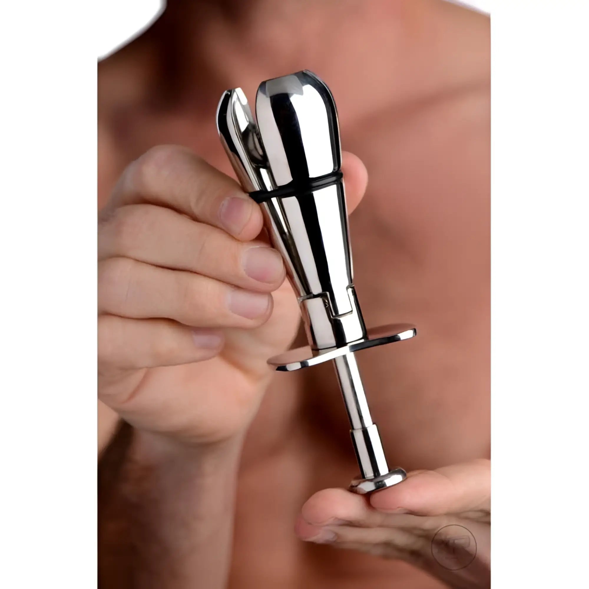 Master Series Stainless Steel Locking Anal Plug: a silver, metallic, adjustable-tip plug held in person's hands.