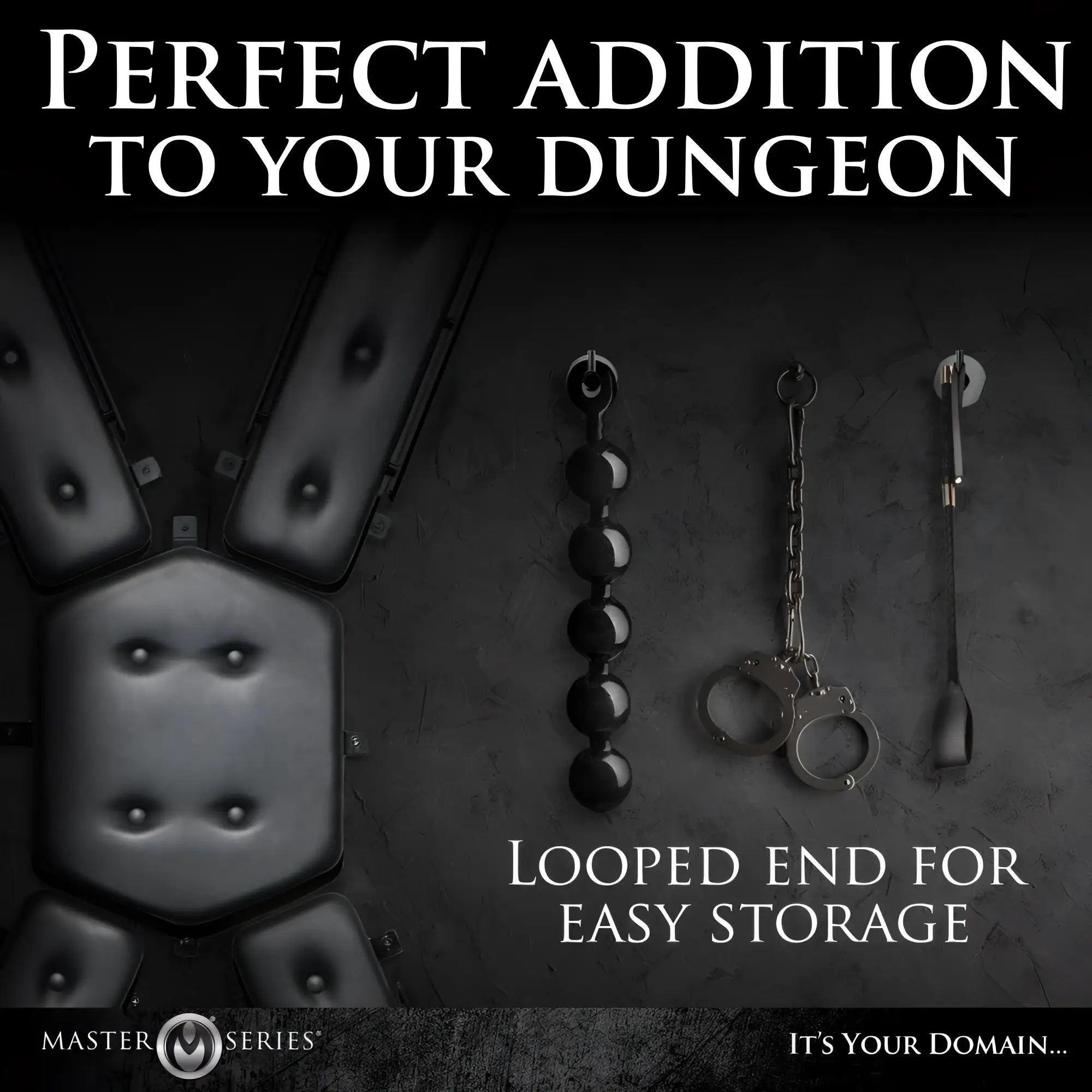 Master Series Stallion Riding Crop in black, shown hanging on a wall alongside other black bondage accessories.