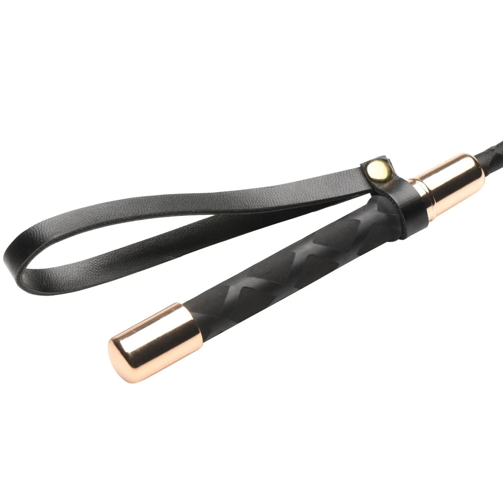 Master Series Stallion Riding Crop with black textured handle, rose gold accents, and a matching black leather wrist loop.