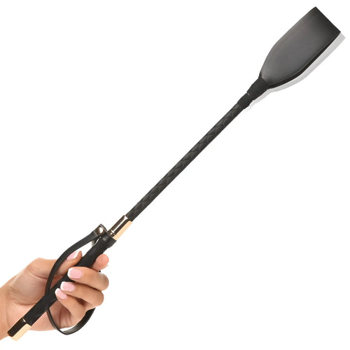 A hand holds a Master Series Stallion riding crop with a black braided shaft, gold accents, and a flat black popper.