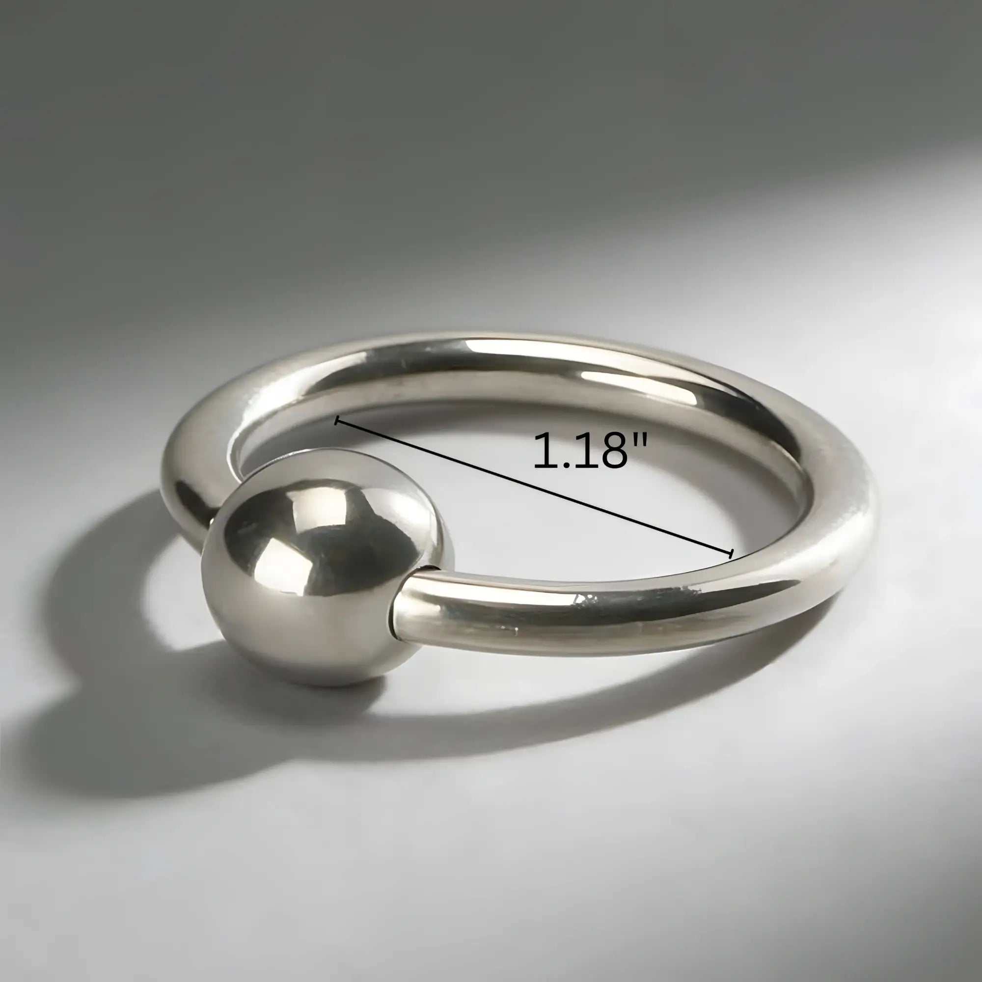 Master Series Steel Ball Head Ring: A polished silver captive bead ring with a 1.18-inch measurement indication.