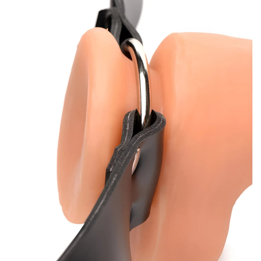 Master Series Strap and Ride harness: A peach-colored silicone dildo base attached to black straps via a metal O-ring.