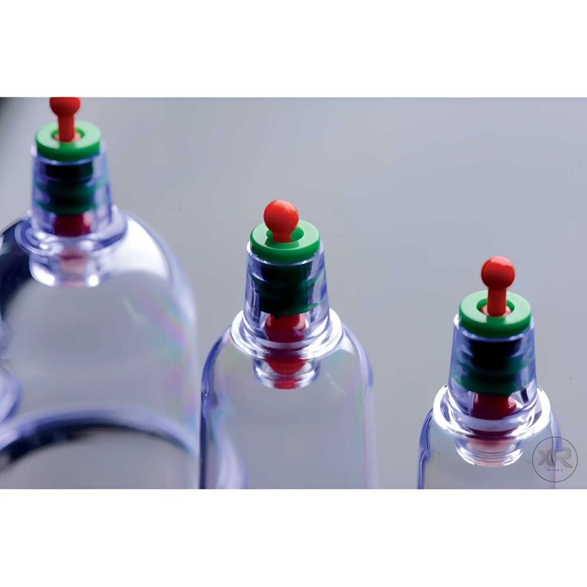 Master Series Sukshen cupping set: three clear plastic suction cups of varying sizes with green rings and red valves.