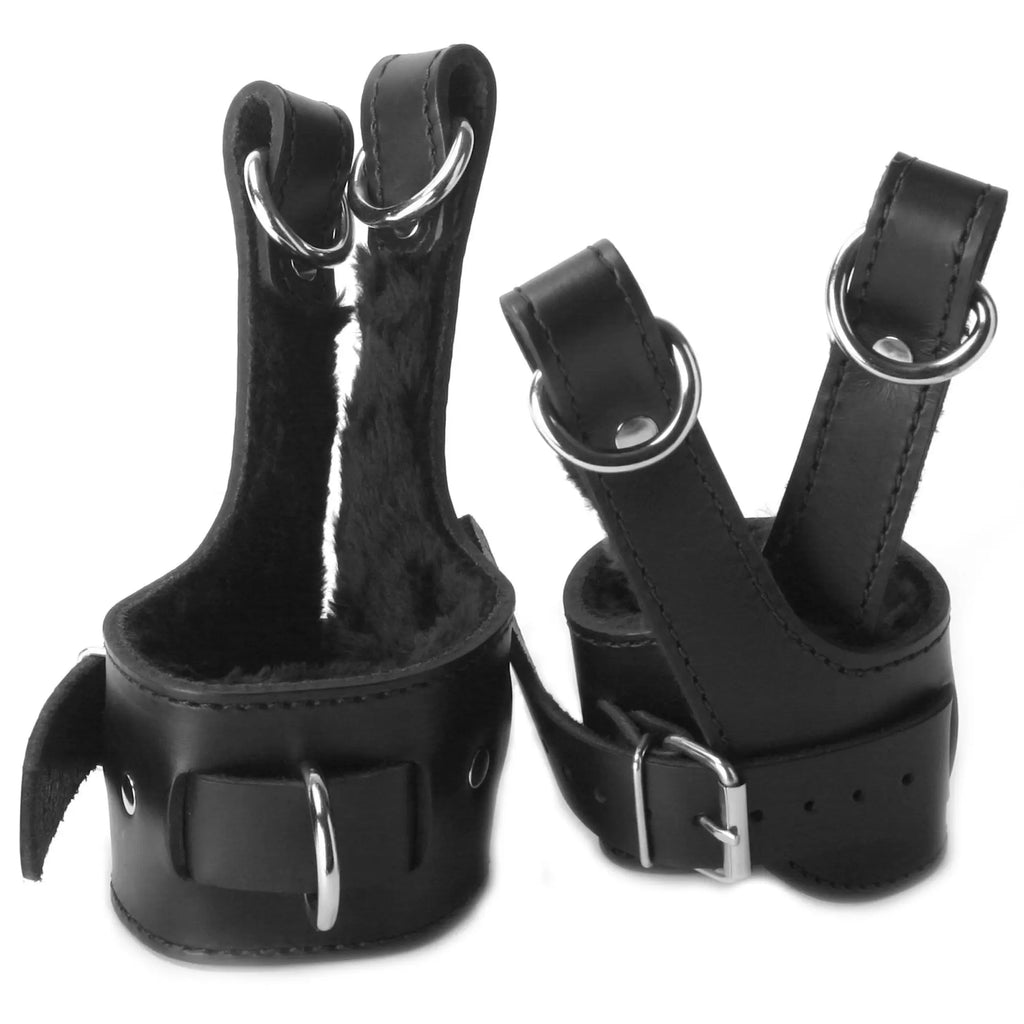 Master Series black leather suspension cuffs featuring plush fur lining, metal D-rings, and adjustable buckle straps.