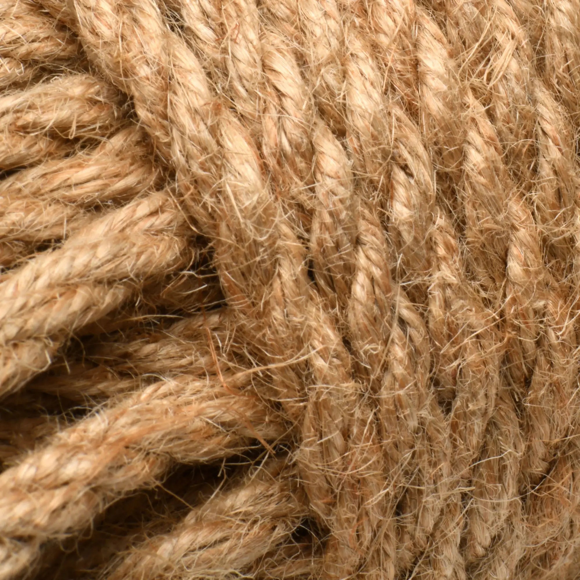 Close-up of Master Series Tied Up Jute Bondage Rope featuring textured, light brown braided natural fiber.