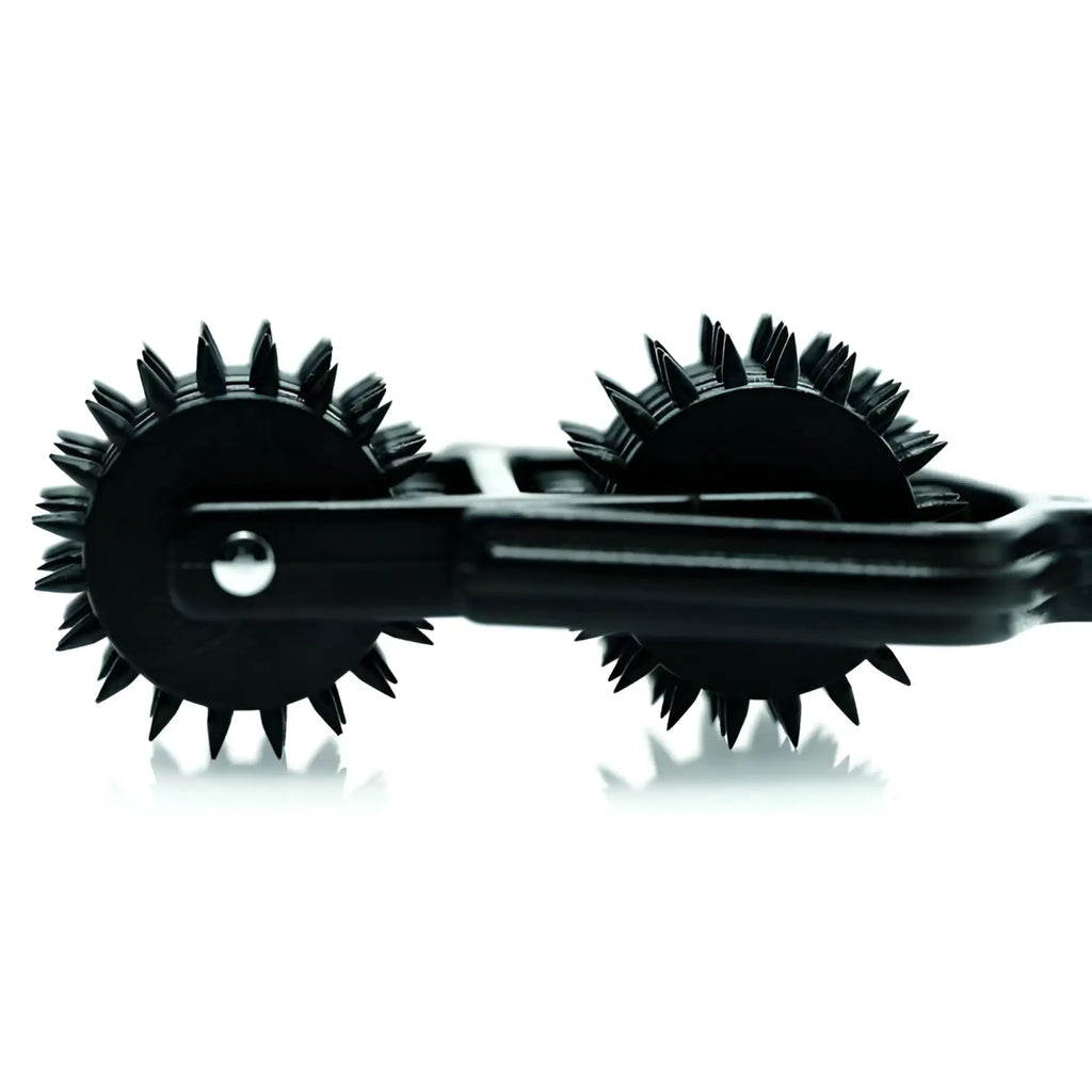 Master Series Transfix 10 Reel Dual Pinwheel: A black sensory tool with two spiked, rotating wheels on a metal frame.