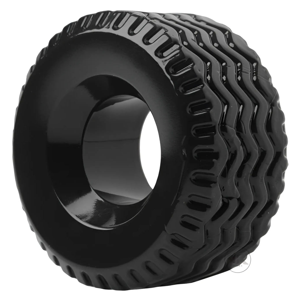Master Series The Tread Ultimate Tire cock ring in shiny black with a rugged, multi-ribbed tire tread texture.