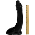 Master Series Tremendous Trevor dildo: a large, black, realistic penis-shaped dildo shown next to a 12-inch ruler.