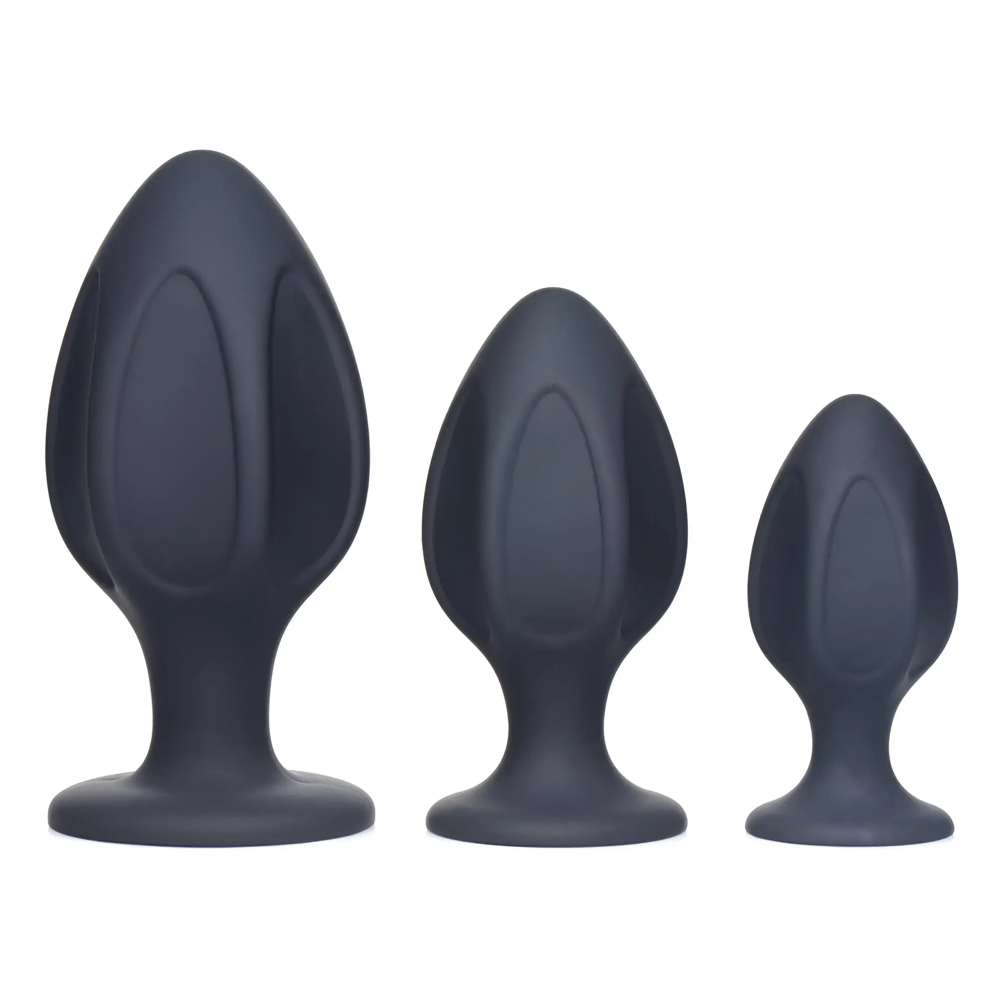 Master Series Triple Juicers: Three charcoal-grey silicone anal trainers of graduated sizes with ribbed, flared bases.