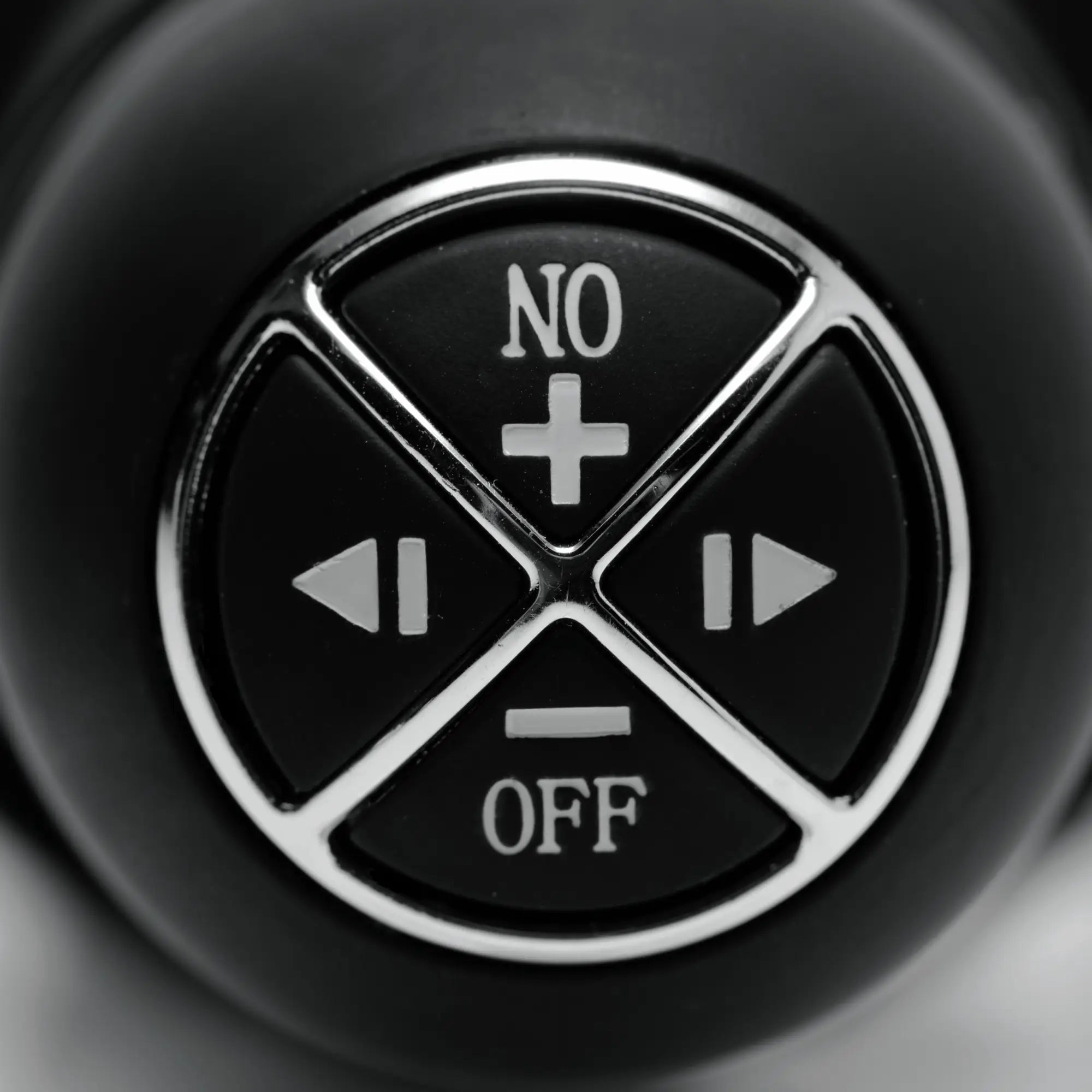 Close-up of the black circular control interface for the Master Series The Violator, featuring silver-rimmed buttons.