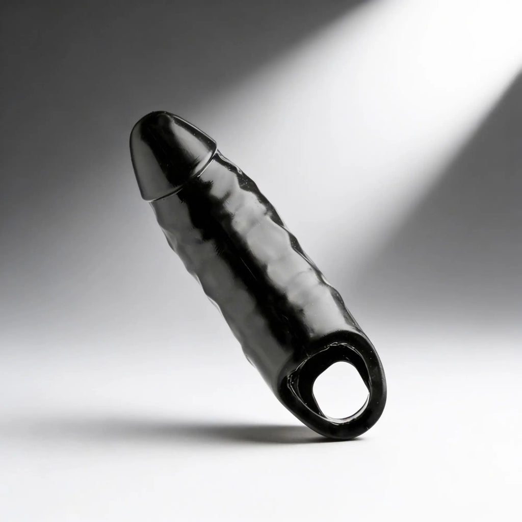 Master Series XL Black Mamba cock sheath in glossy black, featuring a textured design and a circular base ring.