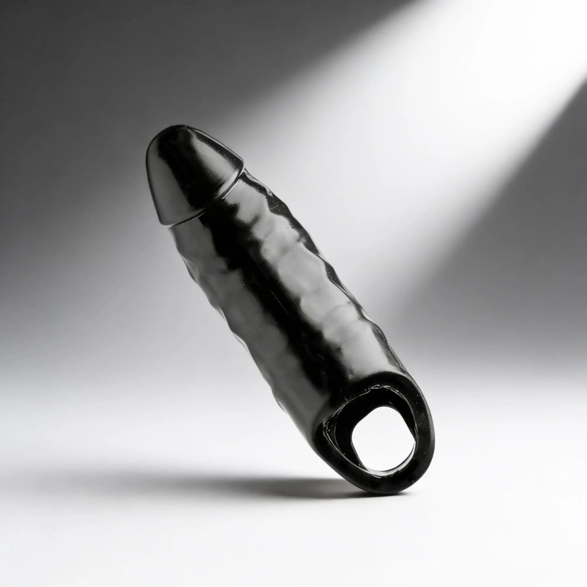 Master Series XL Black Mamba cock sheath in glossy black, featuring a textured design and a circular base ring.