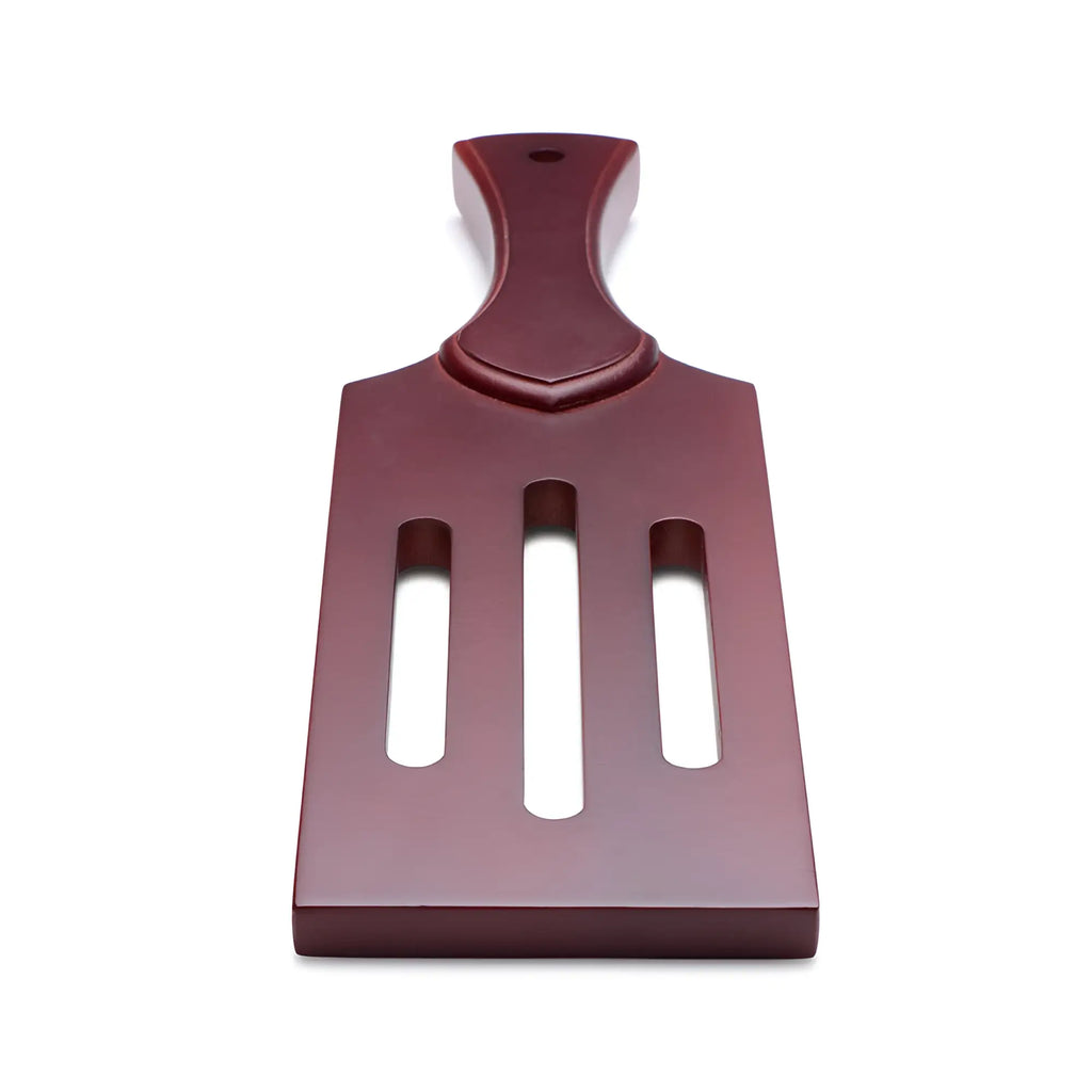 Maroon plastic masters wooden paddle spatula with three vertical slots and contoured handle for cooking tasks
