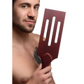 A sleek dark red wooden spatula with three elongated slots and a rounded handle from Masters Wooden Paddle