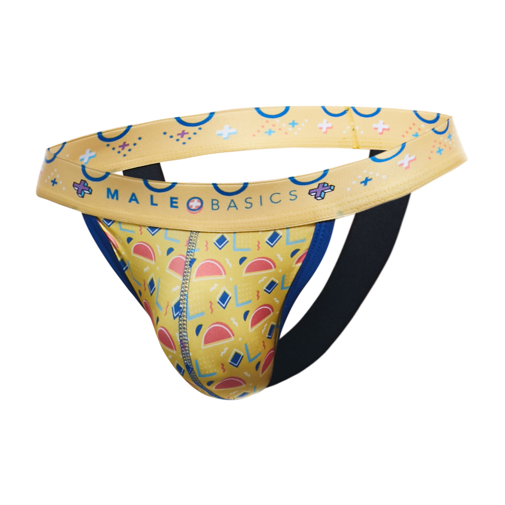A men's jockstrap by MaleBasics featuring a yellow and blue geometric pattern, a wide yellow waistband with blue accents, and a black elastic leg strap, shown against a plain white background.