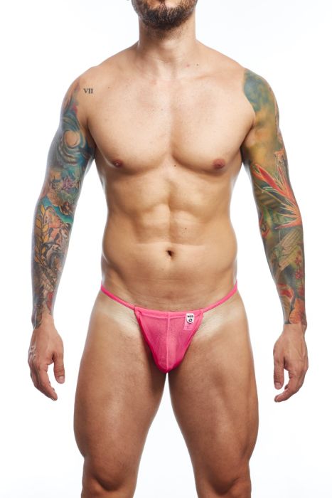 A muscular man with tattoos wearing a bright pink thong-style brief, shown from the waist down against a plain white background.
