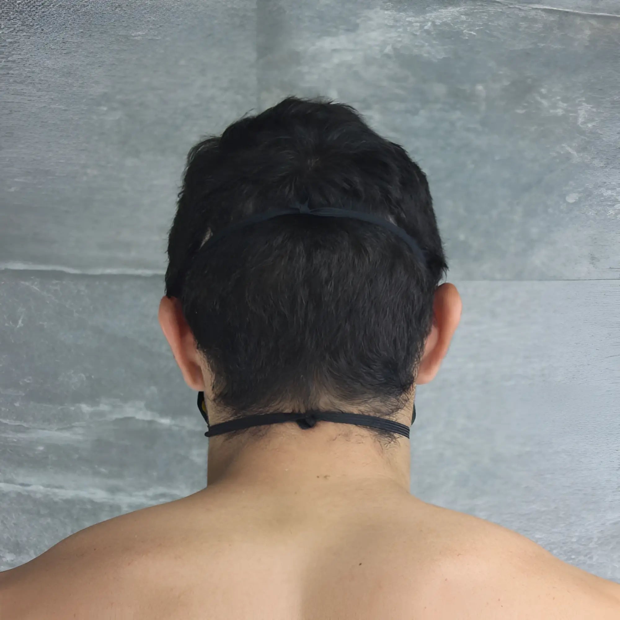 Back view of mckillop polypropylene unisex yellow face mask with black elastic headband size one size