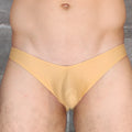 A mustard yellow seamless briefs style undergarment with smooth fabric finish from Mckillop VKDS TA2 Hoist Bikini Naked line