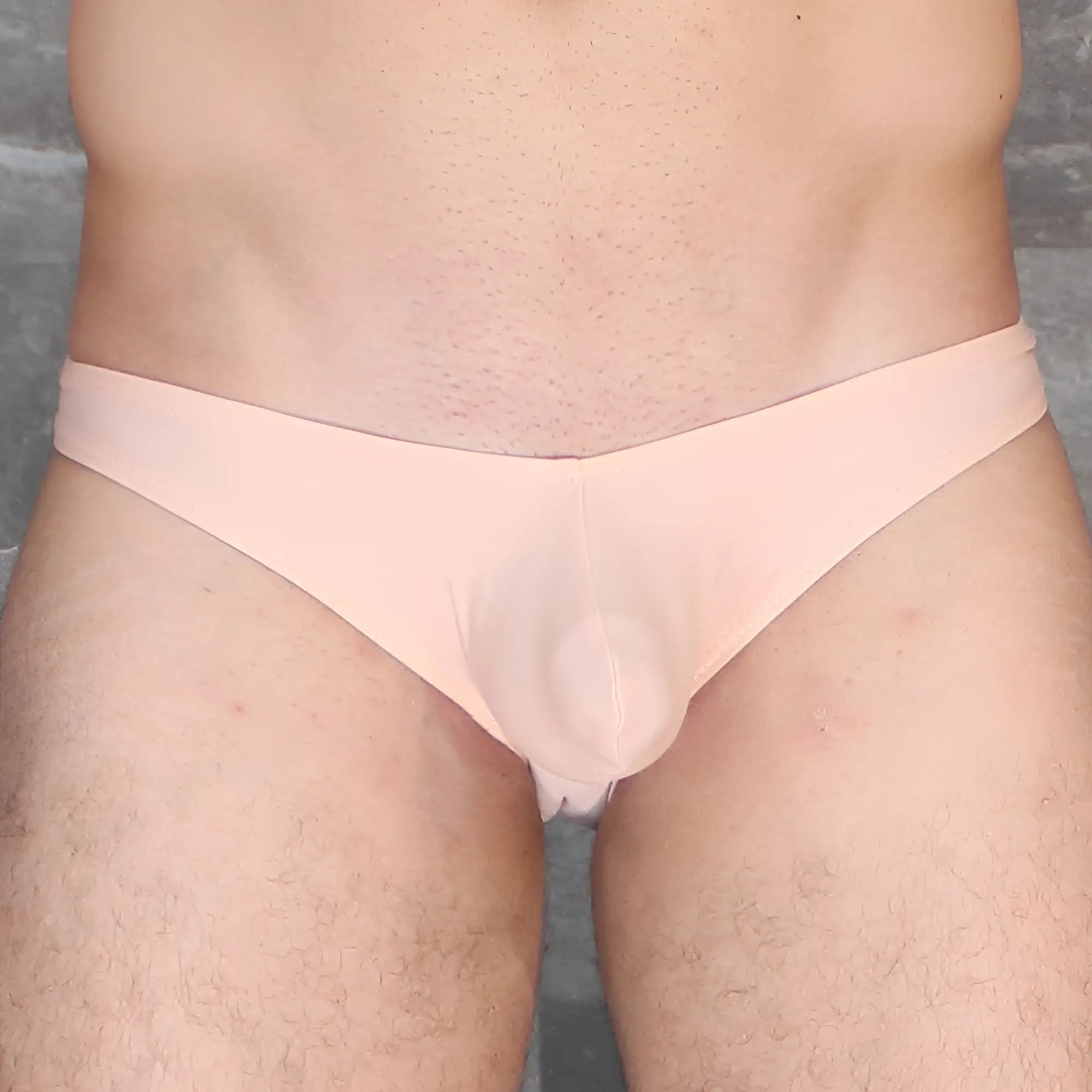 A pale pink sheer fabric thong with a smooth form-fitting design from mckillop vkds ta2 hoist bikini naked collection