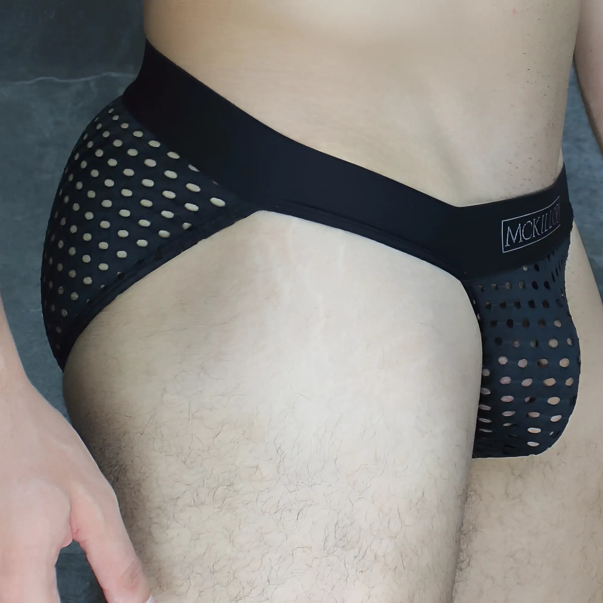 Black mesh mckillip tanga briefs with white polka dots and a solid black waistband made of glory lycra