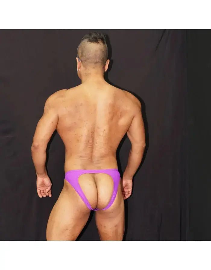 Back view of a model wearing purple backless bikini underwear by Arroyman featuring a minimal design and soft fabric.