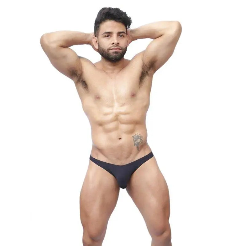 Men's black bikini underwear by Arroyman featuring a sleek design and minimal coverage shown on a model.