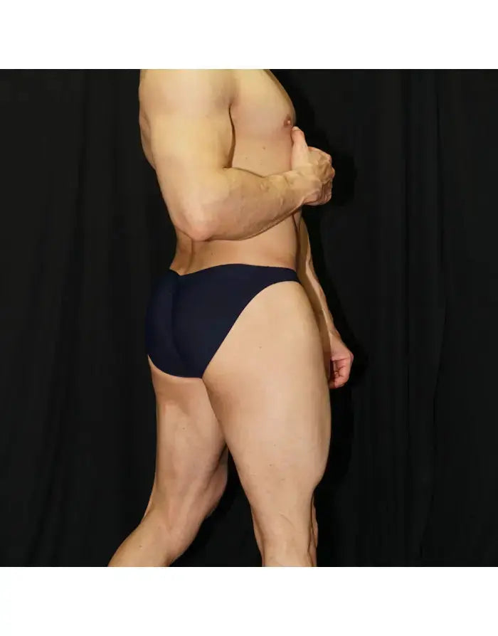 Navy men's bikini underwear by Arroyman featuring a snug fit and smooth fabric shown on a model from the side.