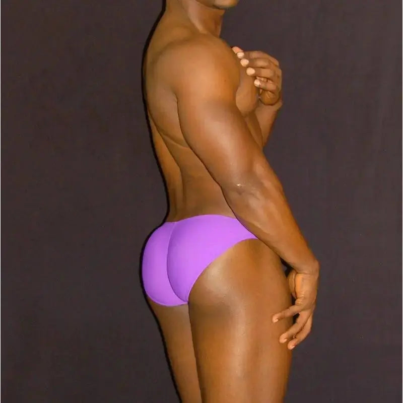 Men's purple bikini underwear by Arroyman featuring a snug fit and smooth fabric shown on a model from the side.