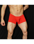 Red boxer underwear by Arroyman featuring a snug fit and soft material shown on a model against a dark background.