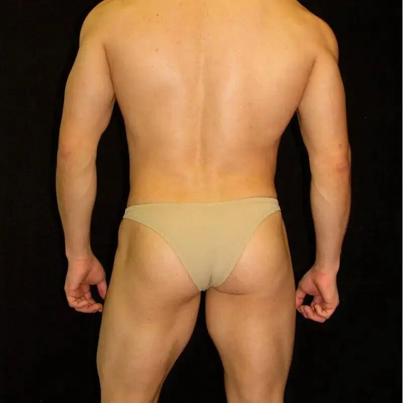 Nude micro bikini underwear for men by Arroyman featuring a minimal coverage design and soft fabric shown on a model from the back.