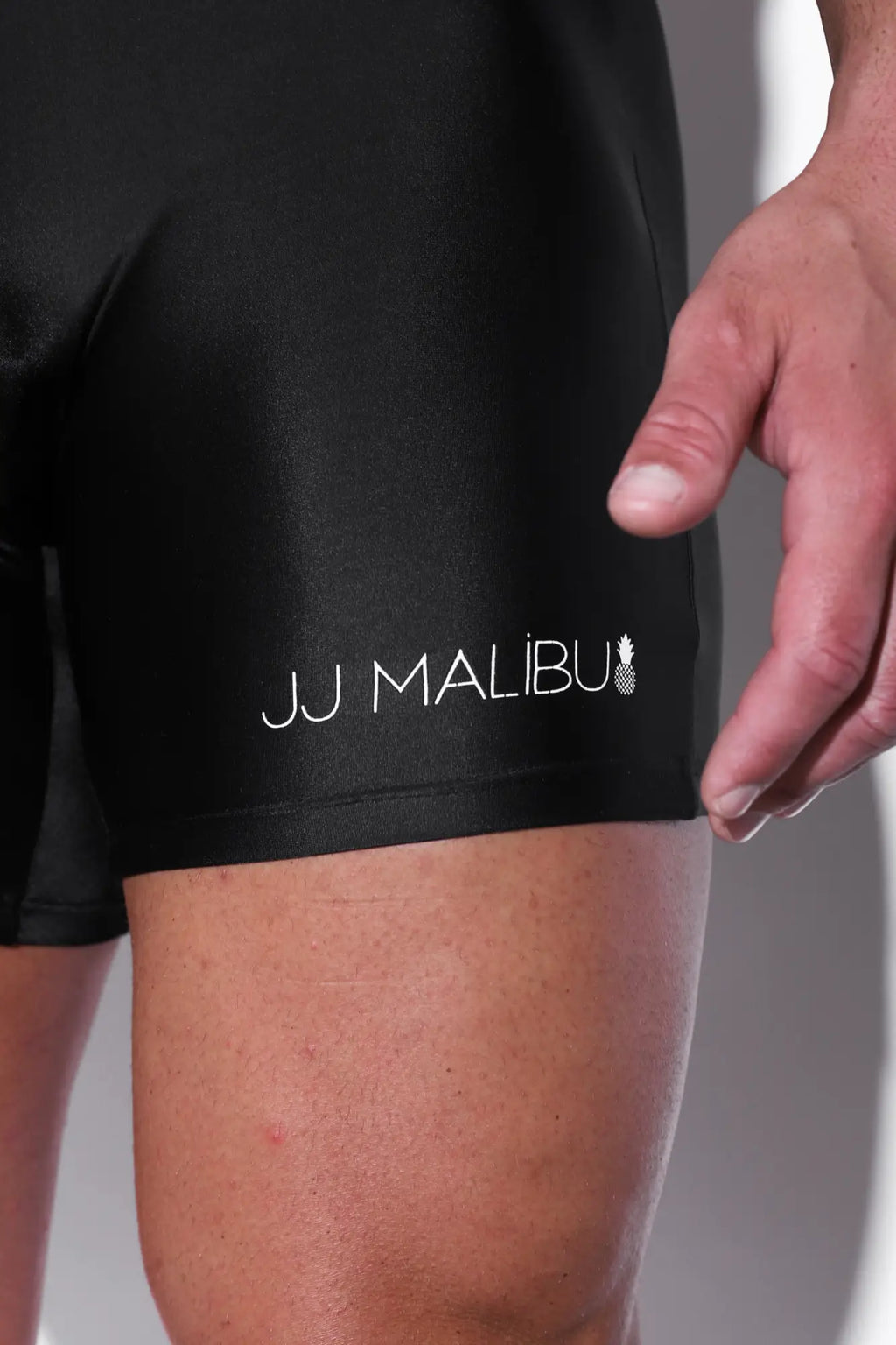 Men’s athletic wrestling singlet bodysuit obsidian with black jj malibu swim trunks featuring white logo and pineapple emblem