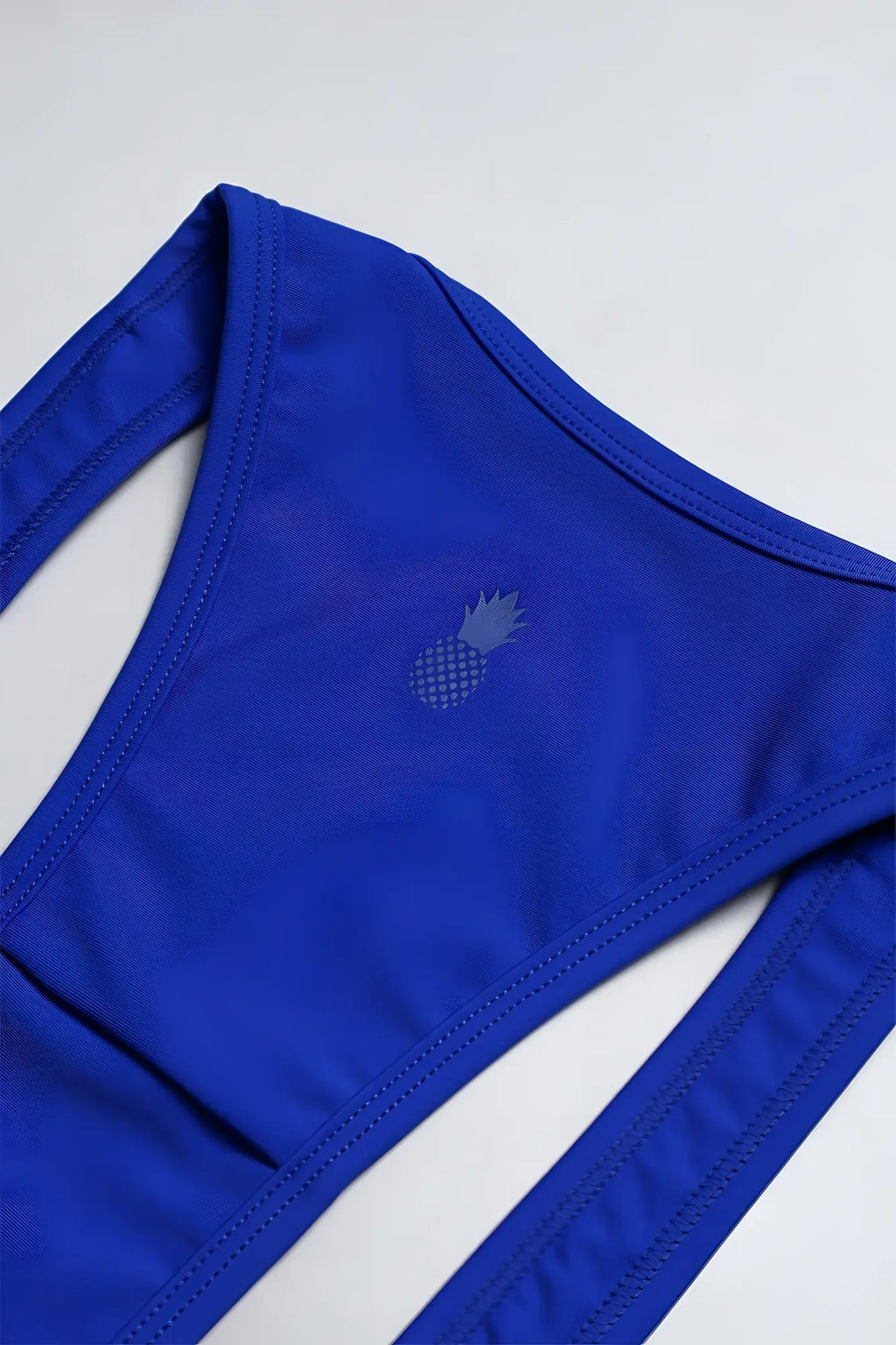 Vibrant royal blue men’s athletic wrestling singlet bodysuit with a subtle gray pineapple emblem on the front