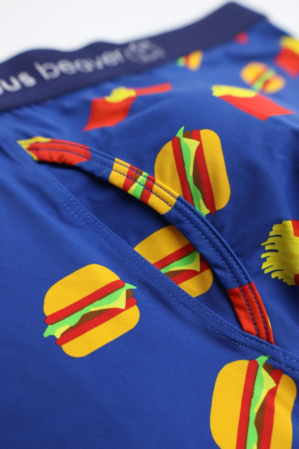 Men’s blue boxer briefs featuring a playful cartoon hamburger pattern in yellow red and green for everyday comfort