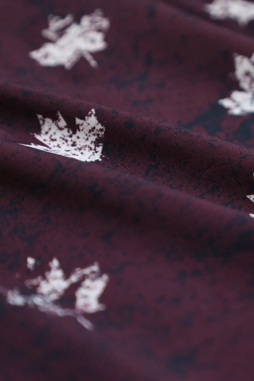 Men’s boxer briefs with maroon fabric and white leaf patterns featuring the canada flag design