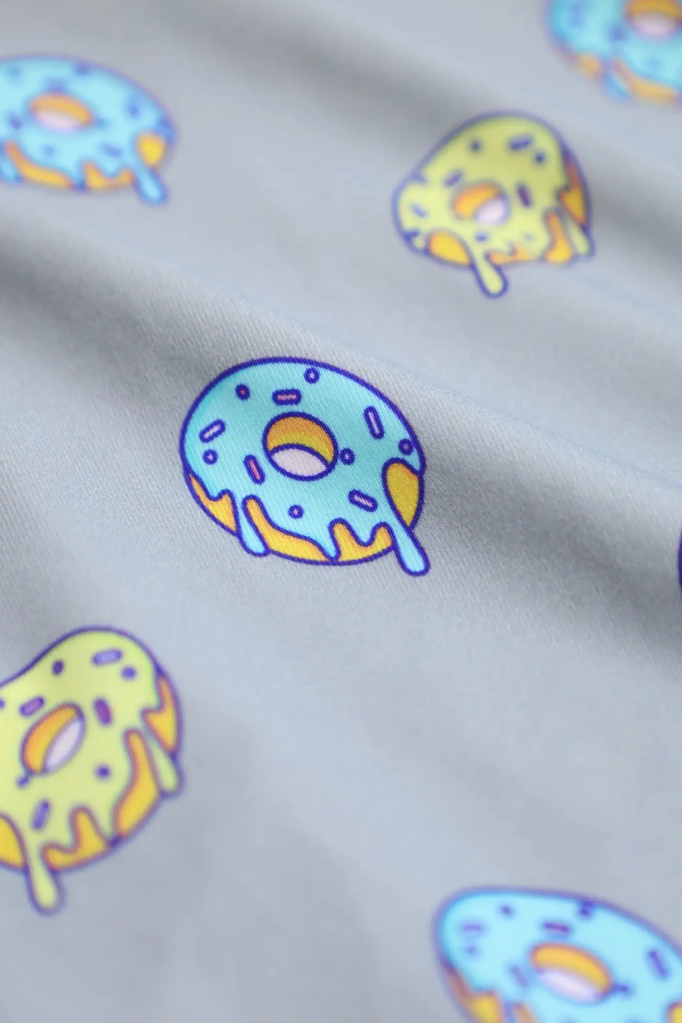 Men’s light gray boxer briefs with playful cartoon donuts pattern featuring blue and yellow icing and sprinkles